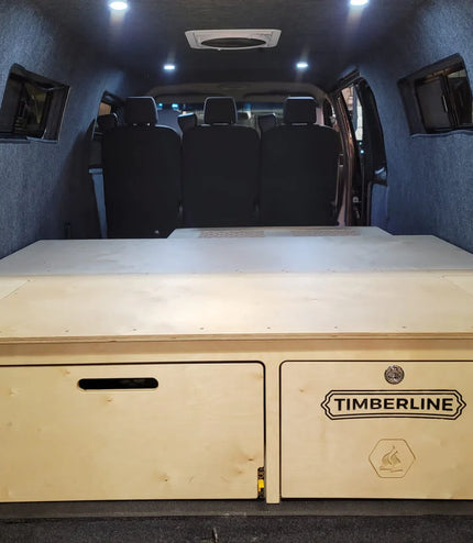 full view of sleeping platform with two generous drawers for storage - great for low or high roof camper vans!