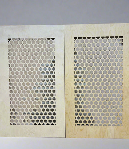 2 plywood boards leaning against a wall with honeycomb pattern on a grey background
