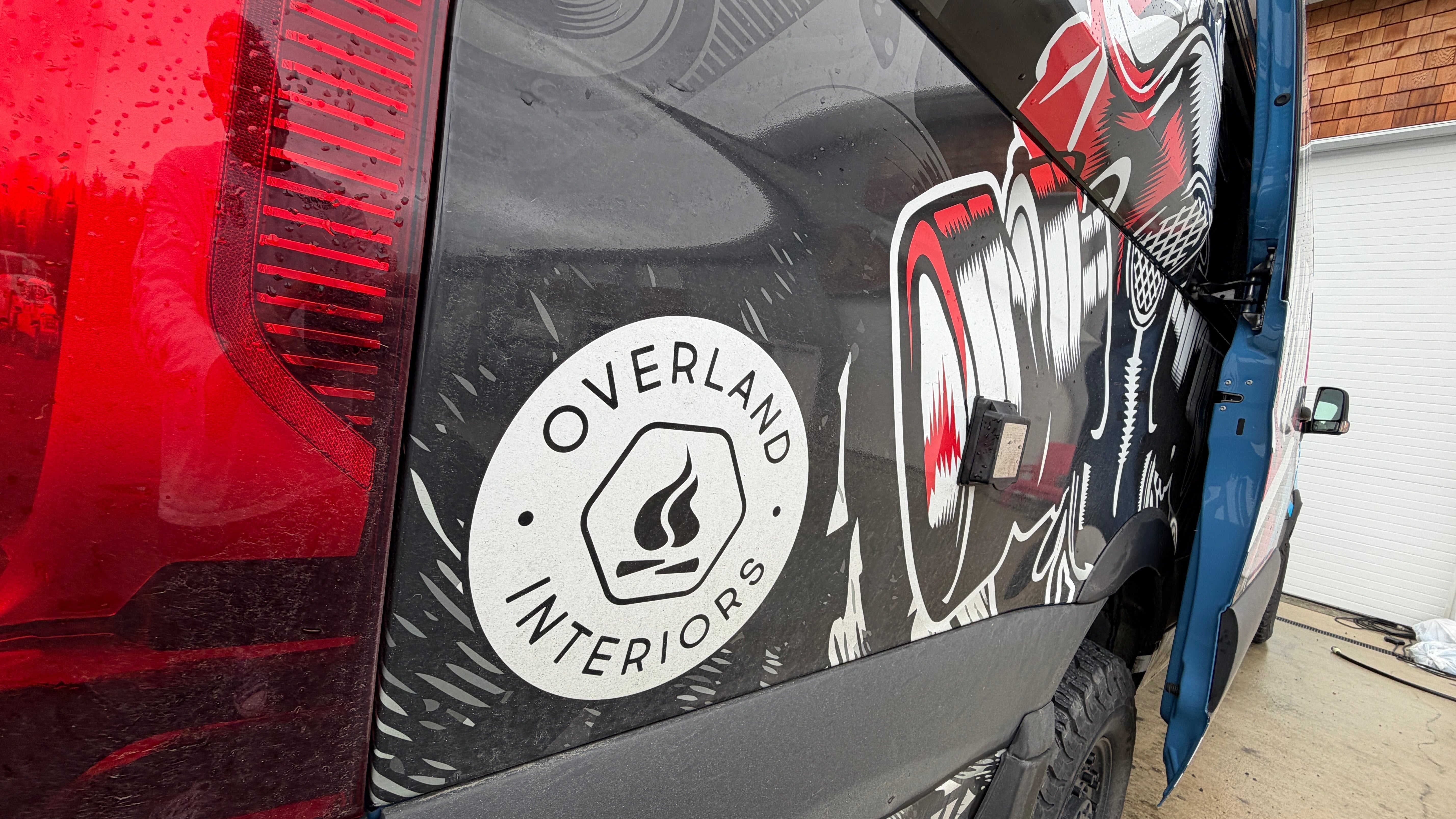 exterior of van with the overland interiors logo on the side