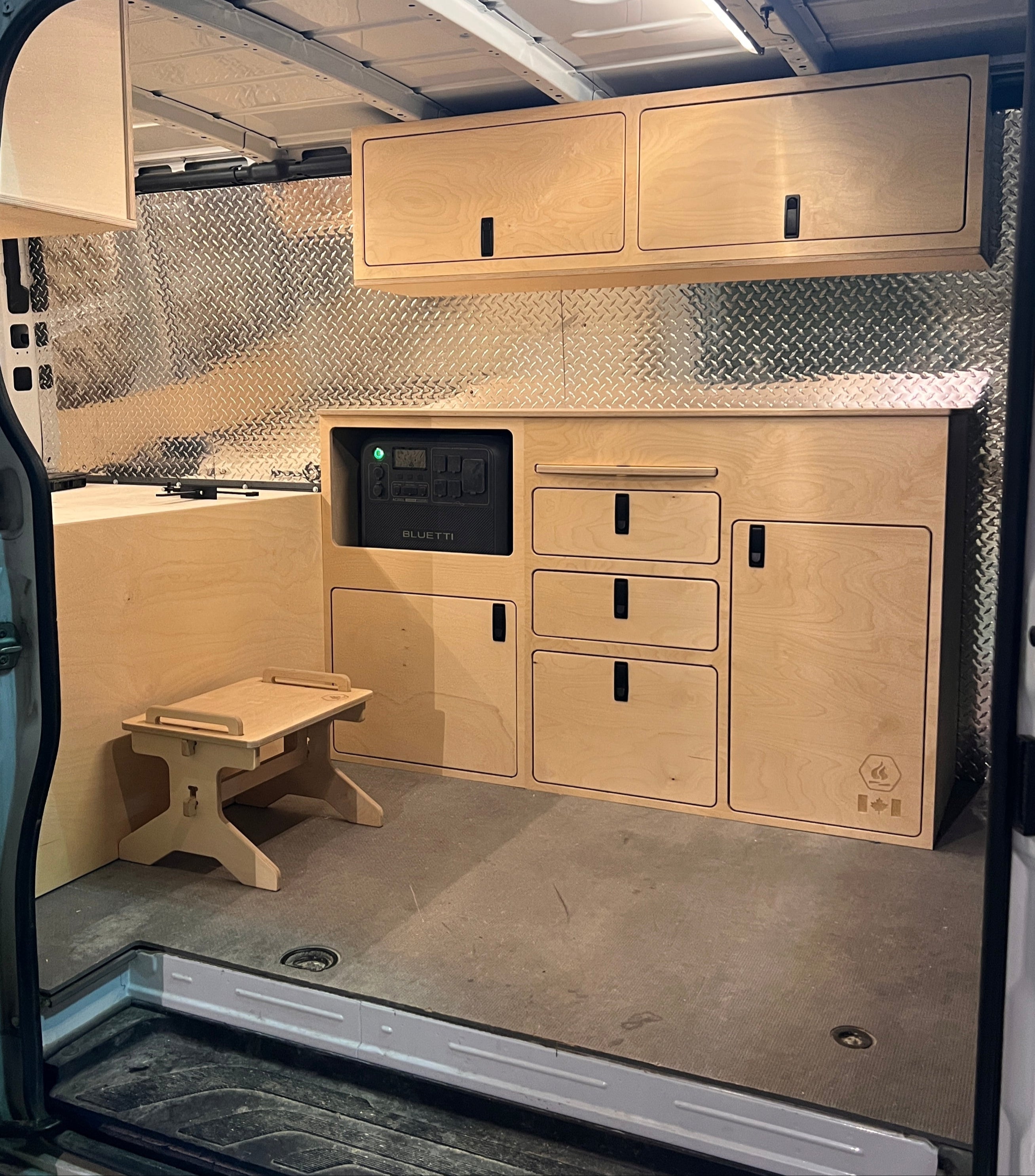 interior build of a mercedes sprinter with wooden cabinets