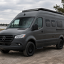 Custom Mercedes Sprinter 144 adventure van built by Overland Interiors parked beside a Maryland waterfront, showcasing a modular camper van conversion designed for organized travel and life on the road.