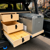 
Custom rear drawer storage system with slide-out Dometic fridge installed in a 2024 Jeep Wrangler 4xe with organized overland camping storage by Overland Interiors.
