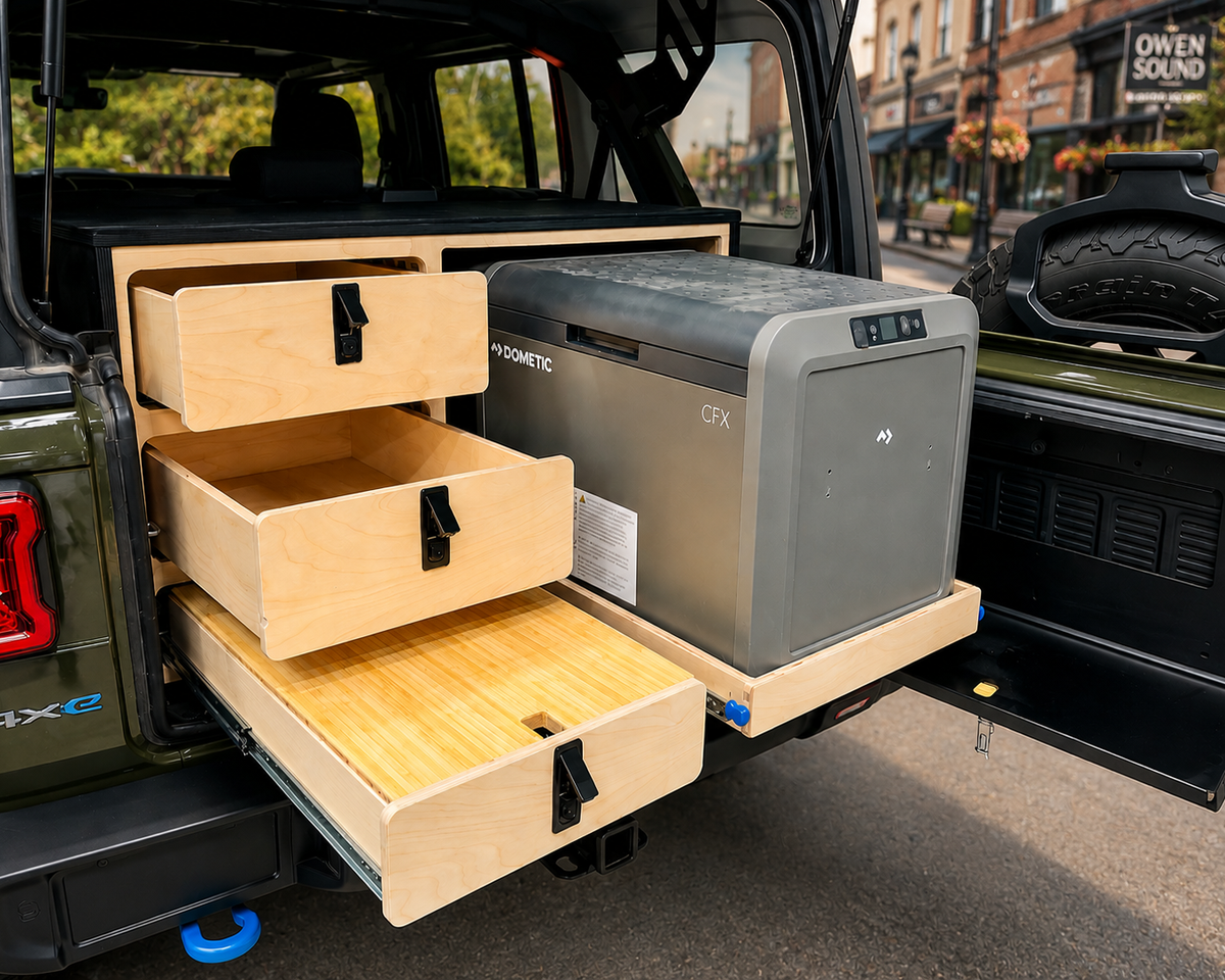 
Custom rear drawer storage system with slide-out Dometic fridge installed in a 2024 Jeep Wrangler 4xe with organized overland camping storage by Overland Interiors.

