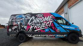 Van with 'The Chrome Project' and 'Vantoys Off-Road' branding parked outside a building.