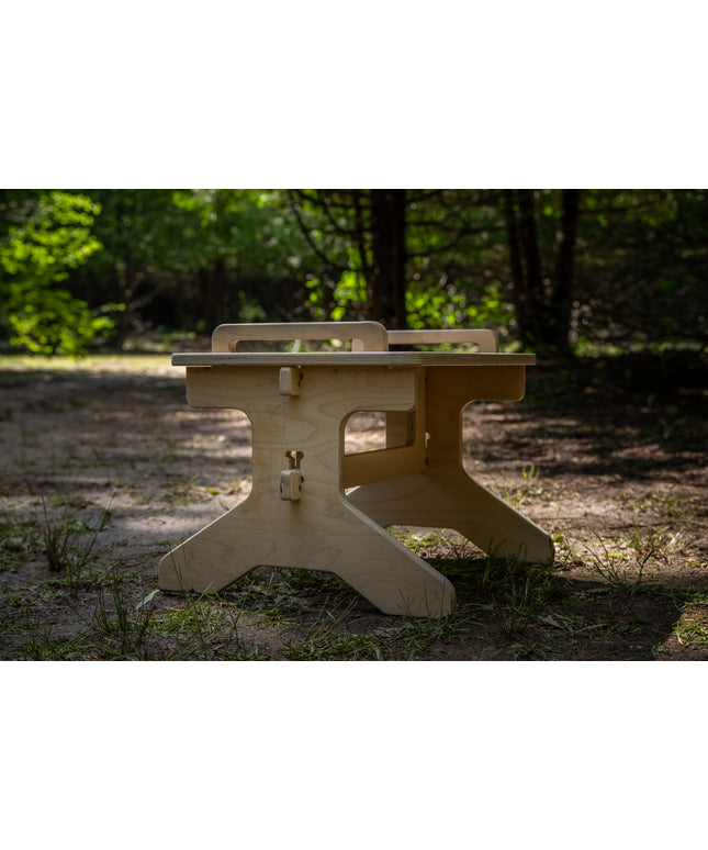 Wooden step stool pictured in a forest setting.  Perfect camper van accessory