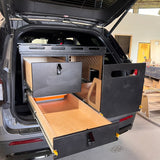 Ford Explorer TrailBase™ Camp Kitchen & Storage System with 400 lb heavy-duty fridge slide, deep dovetail storage drawer, and dedicated camp stove compartment within the rear cargo area.