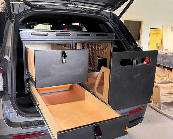 Ford Explorer TrailBase™ Camp Kitchen & Storage System with 400 lb heavy-duty fridge slide, deep dovetail storage drawer, and dedicated camp stove compartment within the rear cargo area.