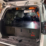 4Runner platform storage system with integrated sleeping platform and rear storage drawers by Overland Interiors.