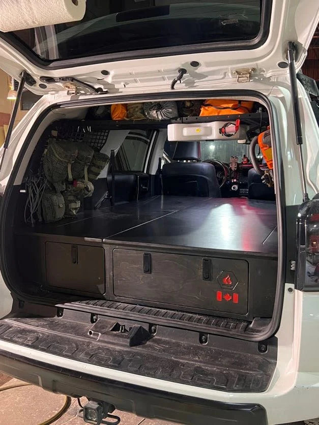 4Runner platform storage system with integrated sleeping platform and rear storage drawers by Overland Interiors.