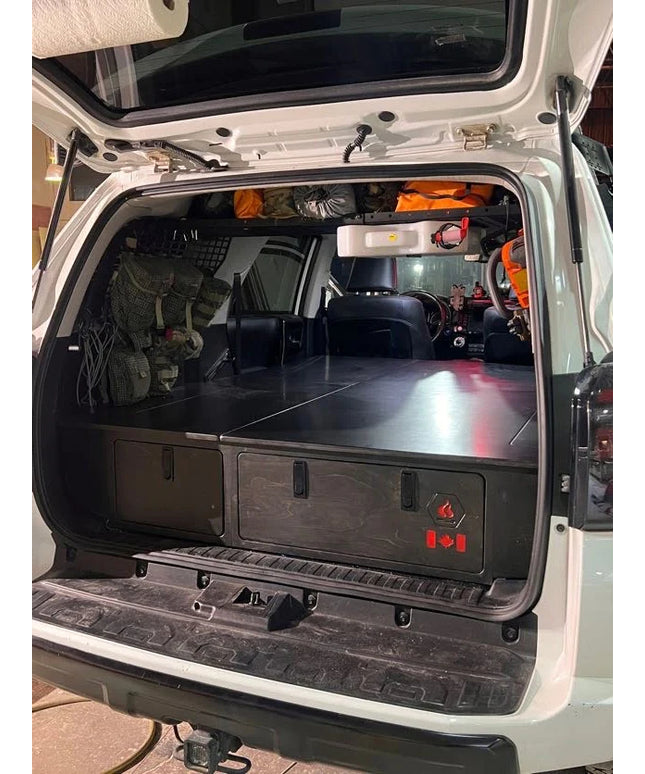 4Runner platform storage system with integrated sleeping platform and rear storage drawers by Overland Interiors.