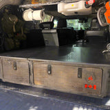 Installed 4Runner sleeping platform with integrated storage drawers for SUV camping and overland travel by Overland Interiors.