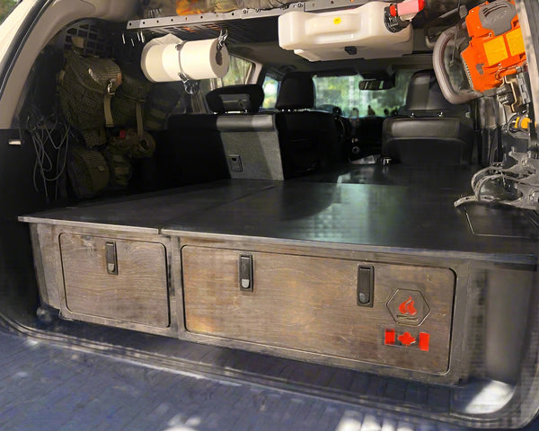 Installed 4Runner sleeping platform with integrated storage drawers for SUV camping and overland travel by Overland Interiors.