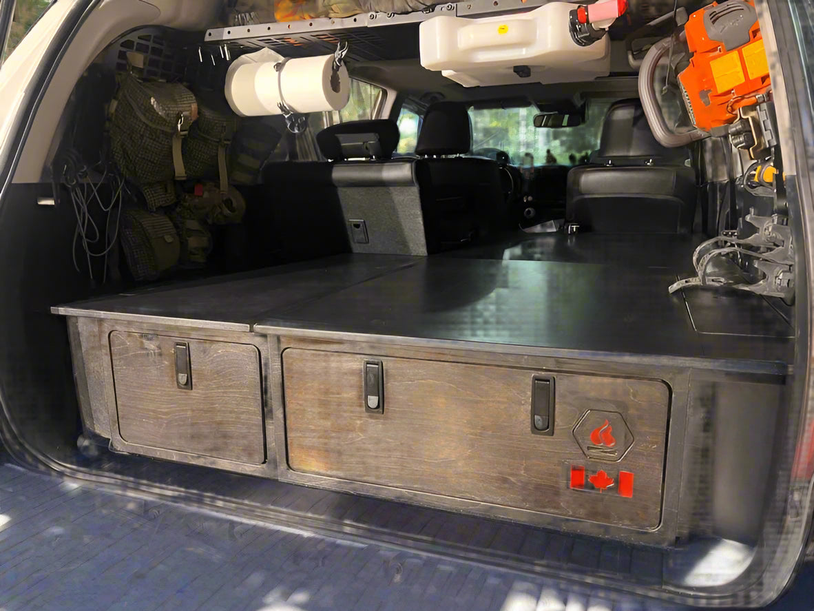 Installed 4Runner sleeping platform with integrated storage drawers for SUV camping and overland travel by Overland Interiors.