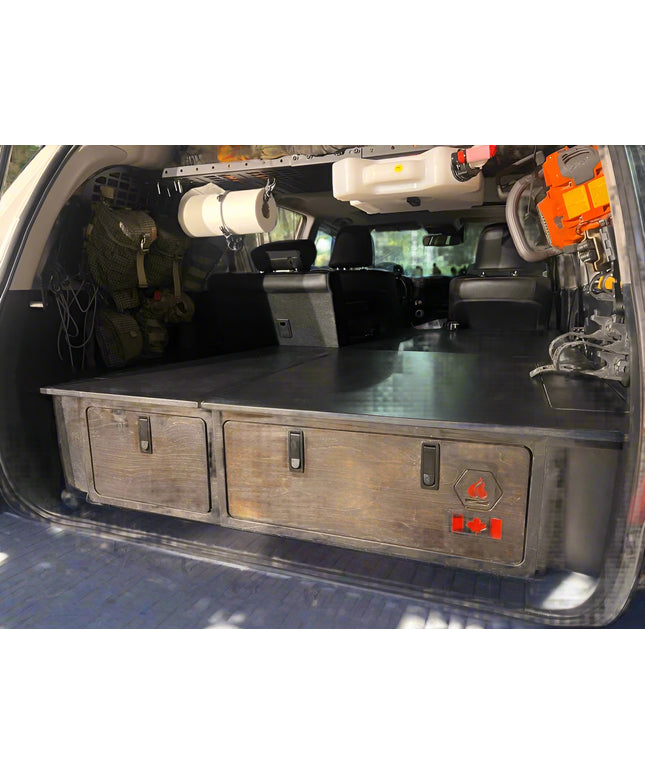 Installed 4Runner sleeping platform with integrated storage drawers for SUV camping and overland travel by Overland Interiors.