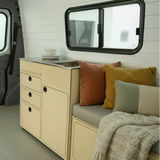 Full capacity camper van kitchenette with sink, water storage, drawers, and kitchen cabinet storage by Overland Interiors