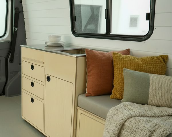 Full capacity camper van kitchenette with sink, water storage, drawers, and kitchen cabinet storage by Overland Interiors