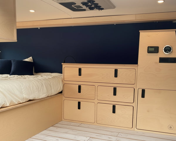Overland Interiors camper van electrical utility cabinet with built-in power controls and storage for van conversions