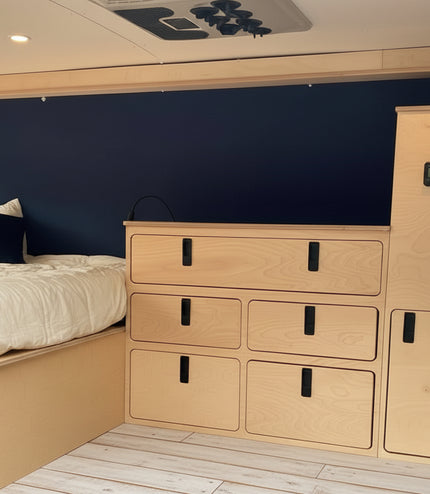 Overland Interiors camper van electrical utility cabinet with built-in power controls and storage for van conversions