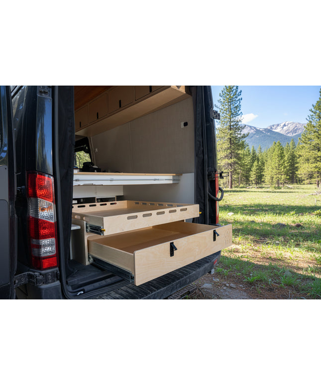 Rear pull-out storage drawer system installed inside a camper van conversion for organized gear and cargo storage by Overland Interiors