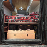 Rear camper van storage drawer and cargo organizer system with pull-out tray and integrated gear storage by Overland Interiors.
