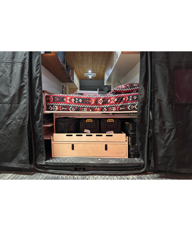 Rear camper van storage drawer and cargo organizer system with pull-out tray and integrated gear storage by Overland Interiors.