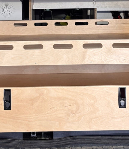 Close-up of a rear pull-out storage drawer and cargo tray system for camper van conversions by Overland Interiors.