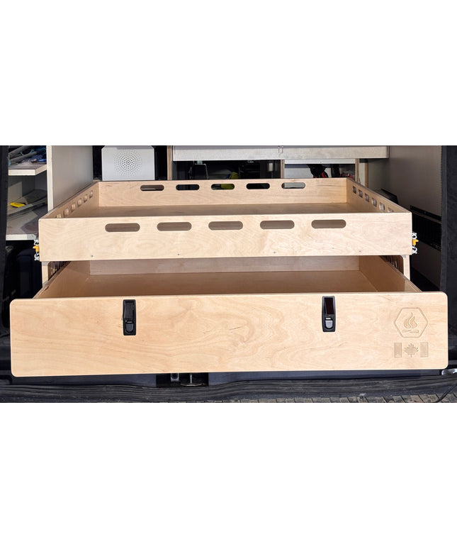 Close-up of a rear pull-out storage drawer and cargo tray system for camper van conversions by Overland Interiors.