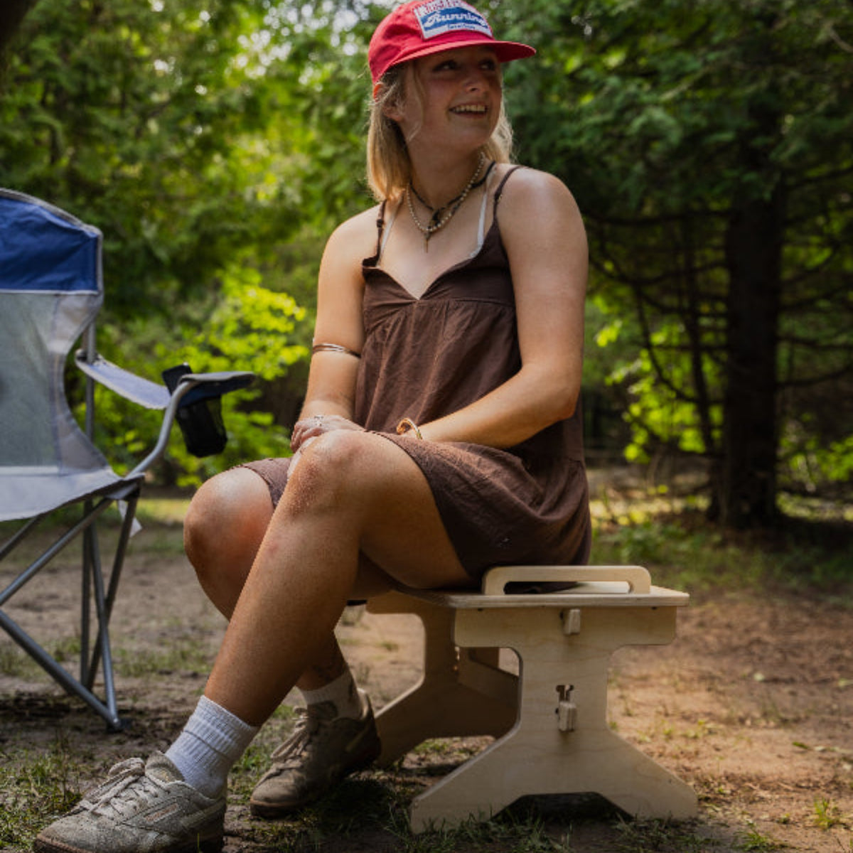 Flat pack camper van step stool used as an extra outdoor camping seat by Overland Interiors