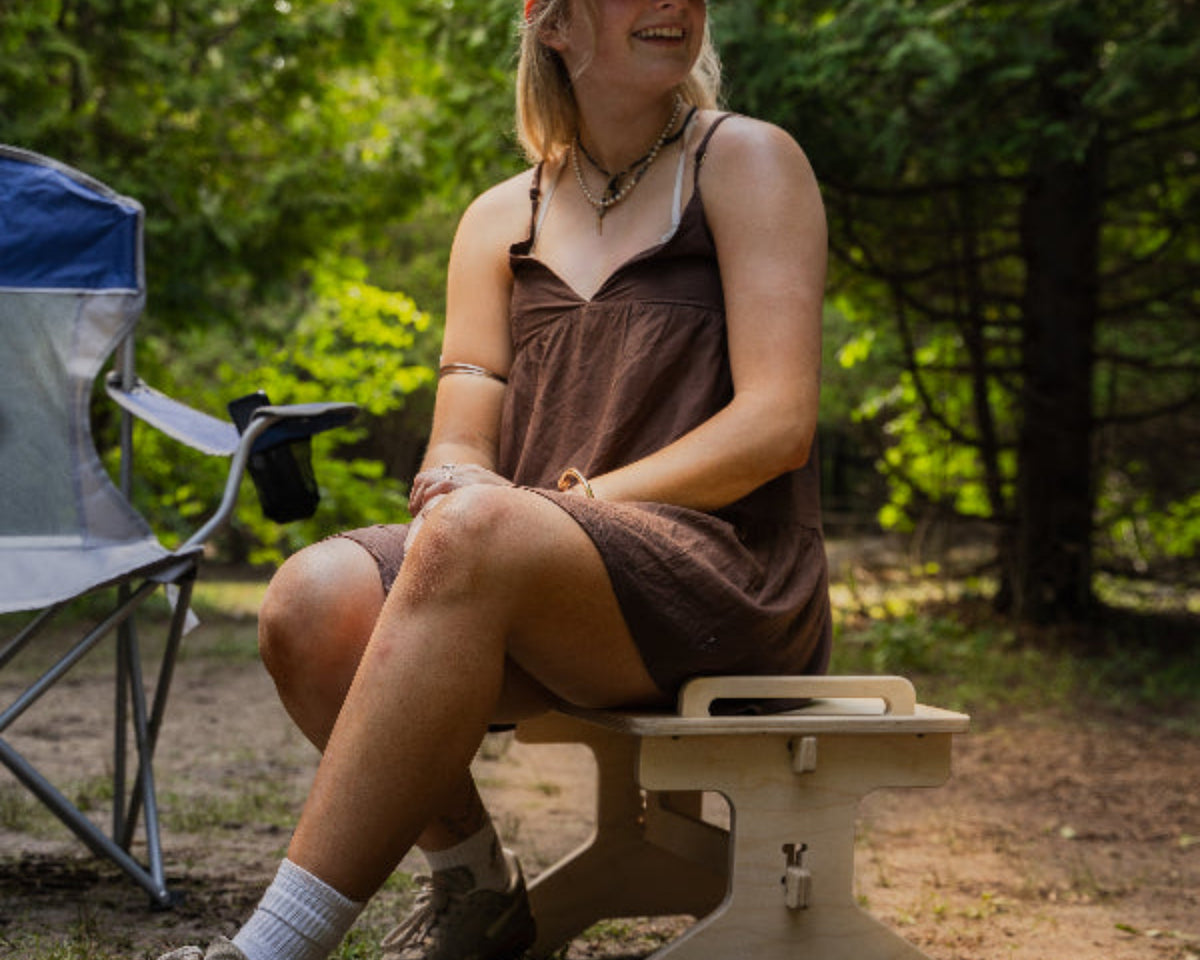 Flat pack camper van step stool used as an extra outdoor camping seat by Overland Interiors