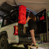 Flat pack camper van step stool in use beside an overland truck camper for easier vehicle access by Overland Interiors