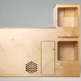 Front view of a compact camper van kitchenette with storage compartments and utility access for van and RV conversions by Overland Interiors