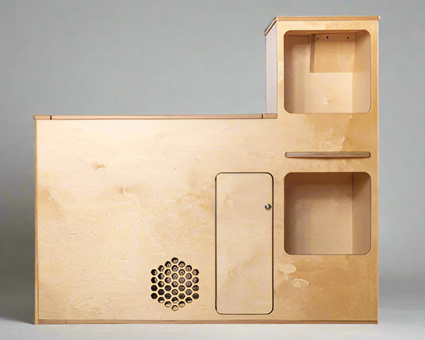 Front view of a compact camper van kitchenette with storage compartments and utility access for van and RV conversions by Overland Interiors