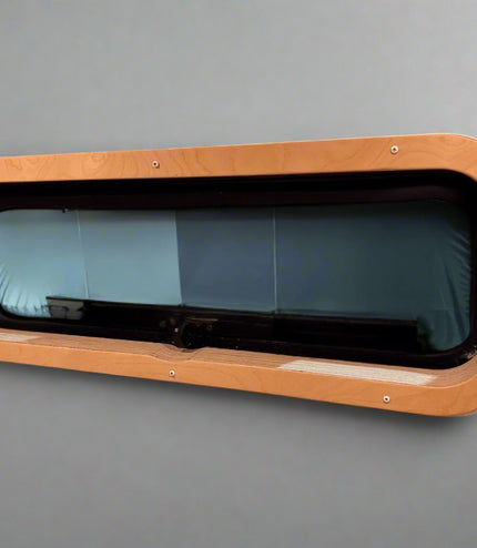 Custom birch interior trim for CR Laurence AW1033 bunk window by Overland Interiors for camper van and overland vehicle conversions.