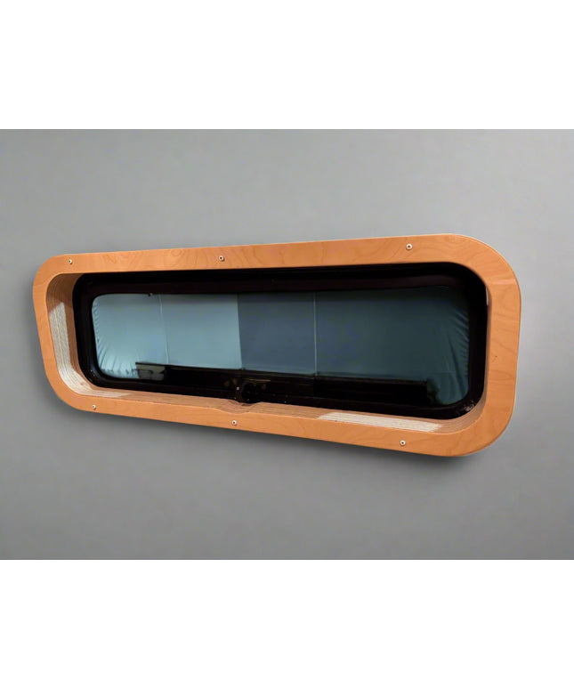 Custom birch interior trim for CR Laurence AW1033 bunk window by Overland Interiors for camper van and overland vehicle conversions.
