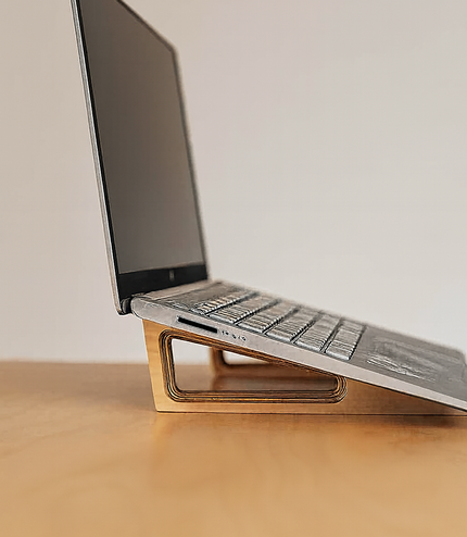 Side view of an ergonomic wooden laptop stand made from Baltic birch by Overland Interiors