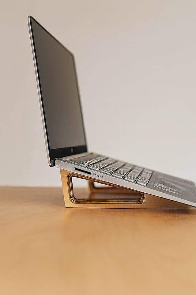 Side view of an ergonomic wooden laptop stand made from Baltic birch by Overland Interiors