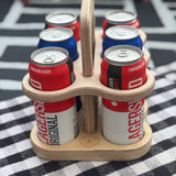 Flat pack birch wooden beer carrier holding six beverage cans by Overland Interiors.
