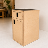 Overland Interiors One+One Base Cabinet in birch plywood with black laminate countertop, shown from the side.