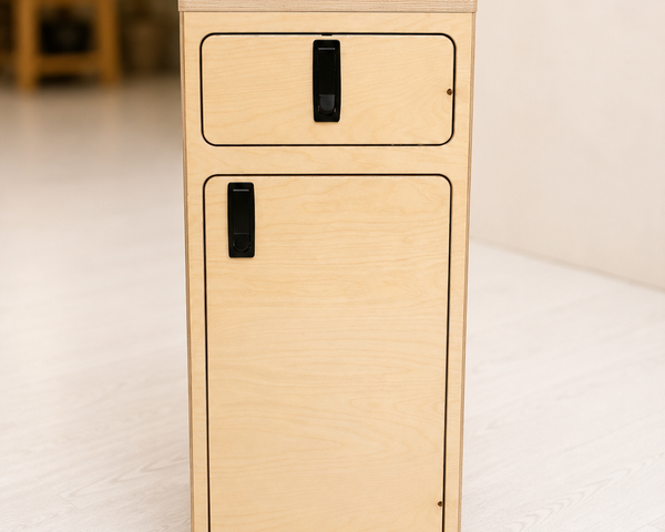 Front view of the Overland Interiors One+One Base Cabinet in birch plywood with upper drawer, lower storage cabinet, black compression latches and black laminate top