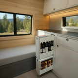 Slim insert cabinet with pull-out narrow storage drawers installed inside a camper van kitchen and storage system by Overland Interiors