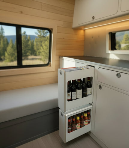 Slim insert cabinet with pull-out narrow storage drawers installed inside a camper van kitchen and storage system by Overland Interiors