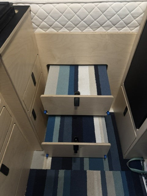 Custom dog step with storage integrated into the rear garage access panel of a Mercedes Sprinter 144 camper van by Overland Interiors.