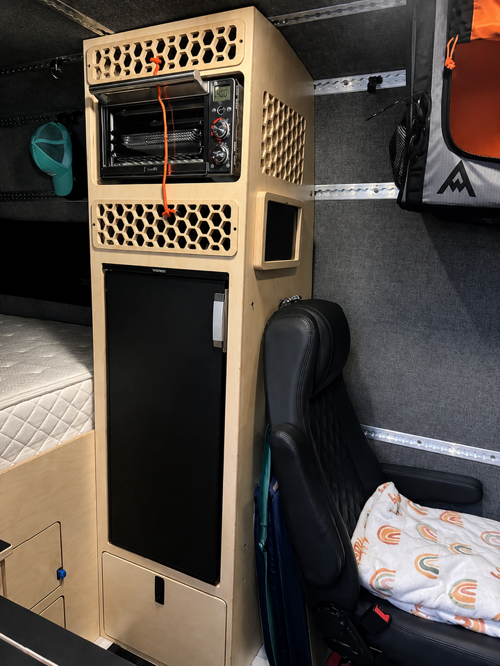Custom fridge cabinet with integrated Breville oven, electrical panel and ventilation in a Mercedes Sprinter 144 camper van