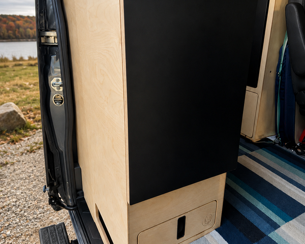 Custom birch plywood kitchen cabinet with counter top inside a Mercedes Sprinter 144 camper van by Overland Interiors