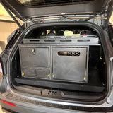 Overland Interiors Trail Series rear kitchen and storage system installed in a Ford Explorer, featuring secure storage cabinets, a pull-out kitchen module, and durable cabinetry for camping and overland travel.
