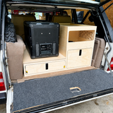 TrailBase™ Vault rear storage system installed in a Classic Range Rover featuring fridge slide, modular storage cabinet, lightweight honeycomb construction made by overland interiors 