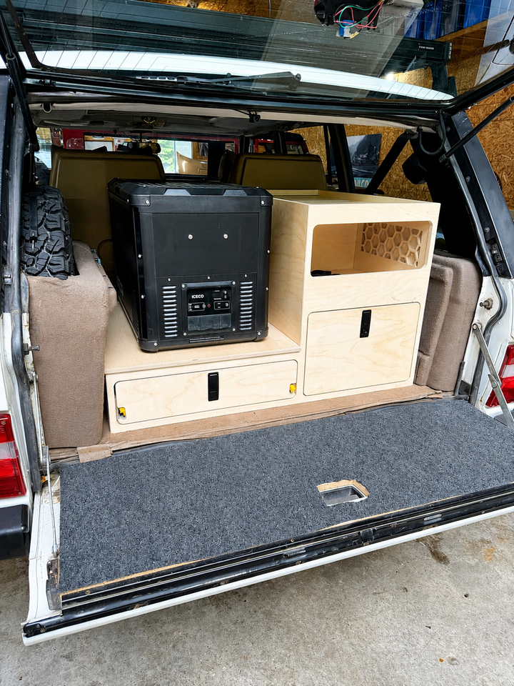 TrailBase™ Vault rear storage system installed in a Classic Range Rover featuring fridge slide, modular storage cabinet, lightweight honeycomb construction made by overland interiors 