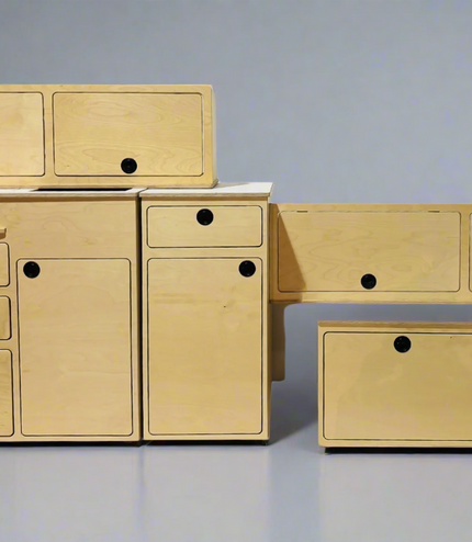 Modular Ford Transit camper van conversion kit components including cabinetry, storage, and interior furniture by Overland Interiors.