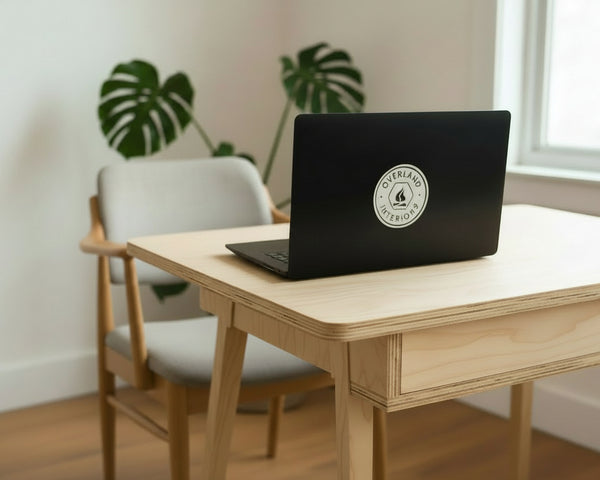 Overland Interiors van life and overland vinyl sticker displayed on a laptop.