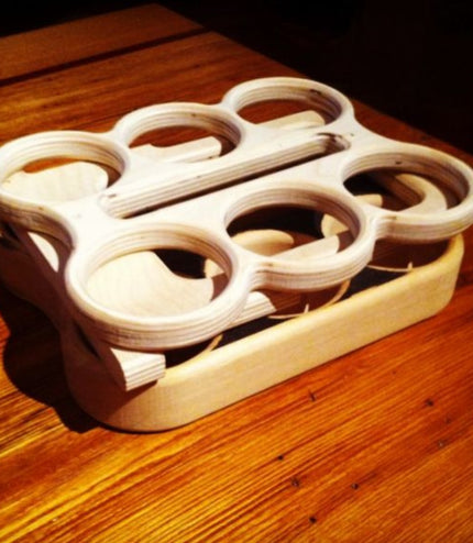 image of flat pack wooden six pack beer carrier on a wooden surface